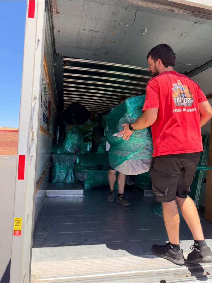 Top Boss crew loading wrapped furniture into the truck