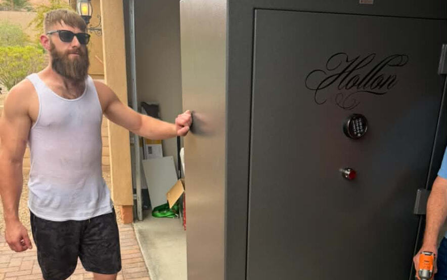 A Top Boss mover moving a large gun safe on a dolly