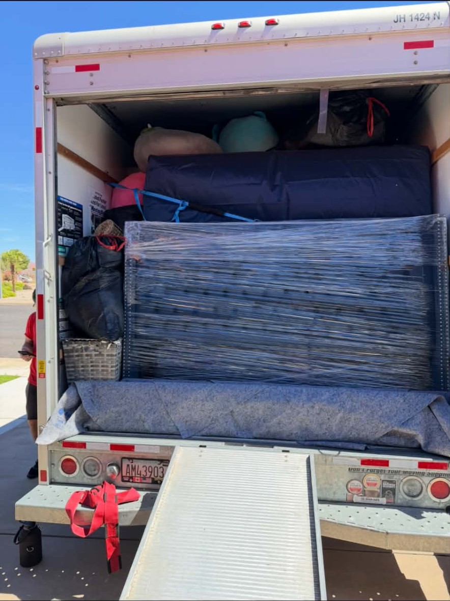 Loaded Top Boss moving truck with protected furniture